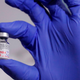 A medical worker displaying a vial of the Pfizer/BioNTech covid-19 vaccine.